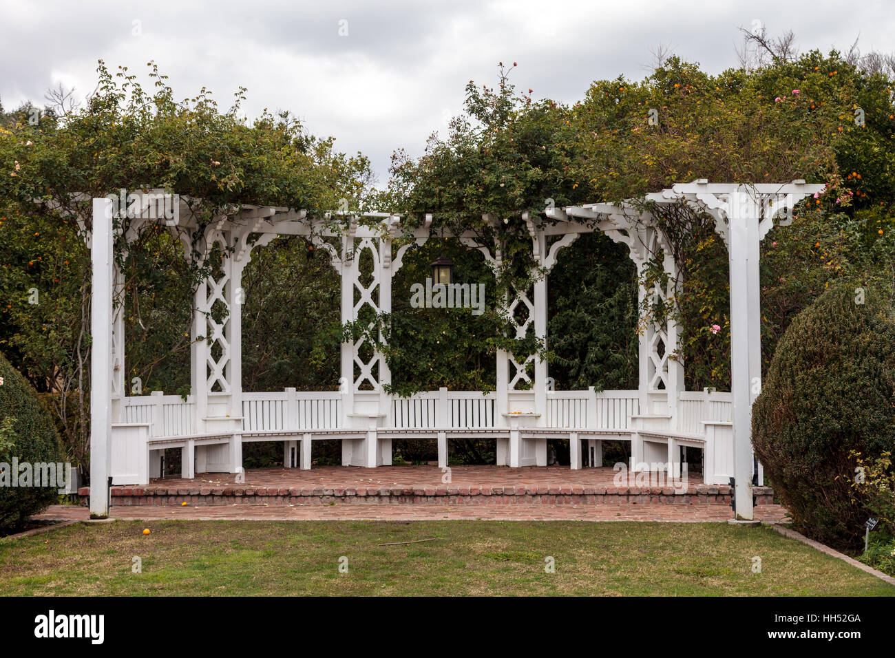 Los Angeles, CA, USA – January 15, 2017: White porch gazebo with lights in a rose garden at the Los Angeles Arboretum in Souther Stock Photo