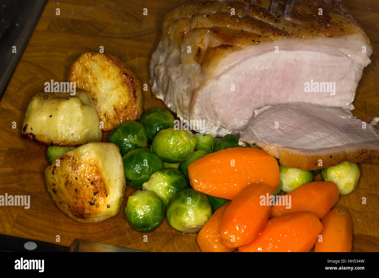 Cooked roast Pork joint with vegetables and potatoes Stock Photo Alamy