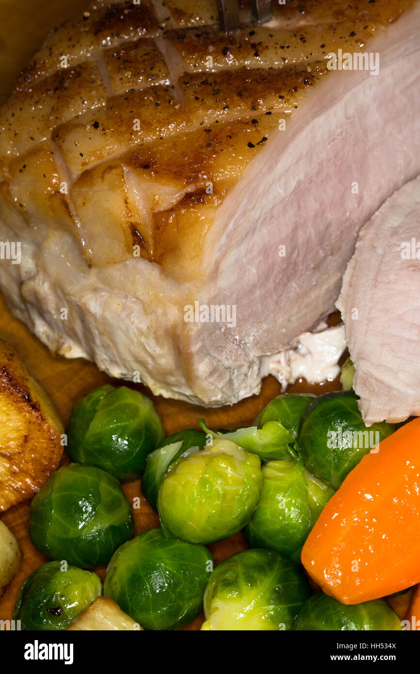 Cooked roast Pork joint with vegetables and potatoes Stock Photo Alamy