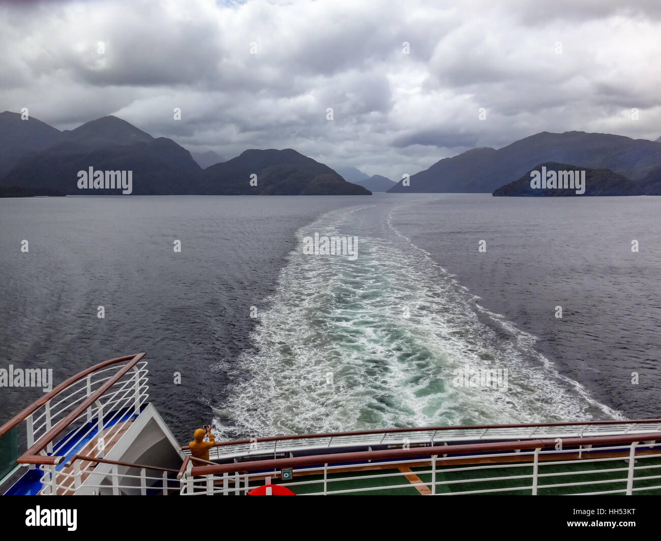 Wake of cruise ship navigating Fiordland, New Zealand Stock Photo
