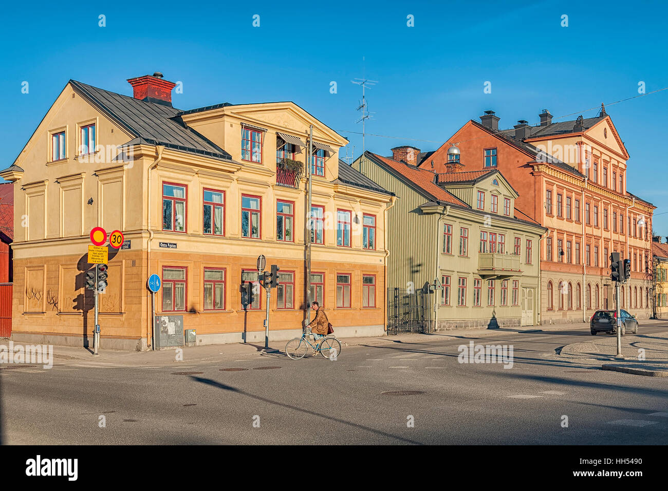 Sparse traffic on a street with historic buildings. Uppsala, Sweden. Stock Photo
