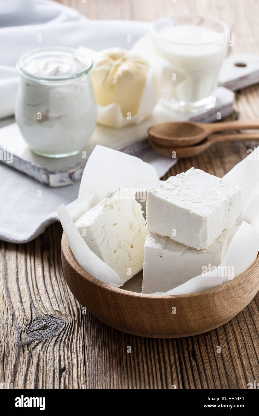 Organic dairy products on rustic wooden table. Cheese, milk, butter, sour cream Stock Photo