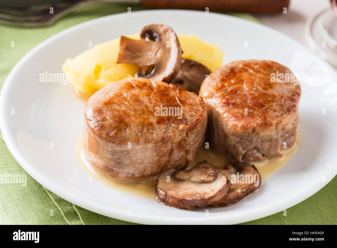 Homemade pork loin fillet with mashed potatoes and mushroom sauce on