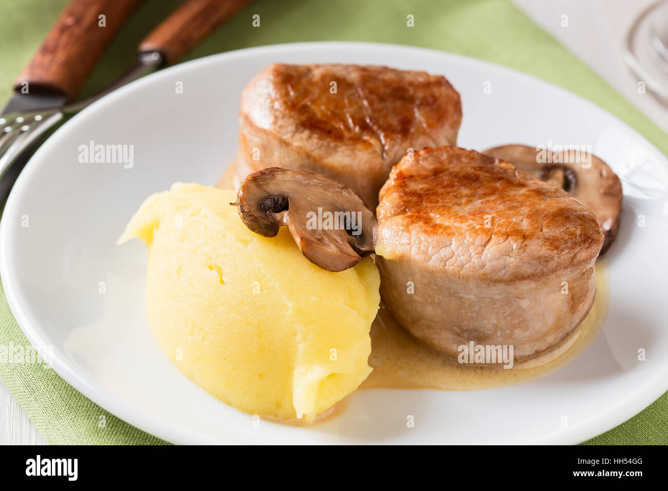 Homemade pork loin fillet with mashed potatoes and mushroom sauce on