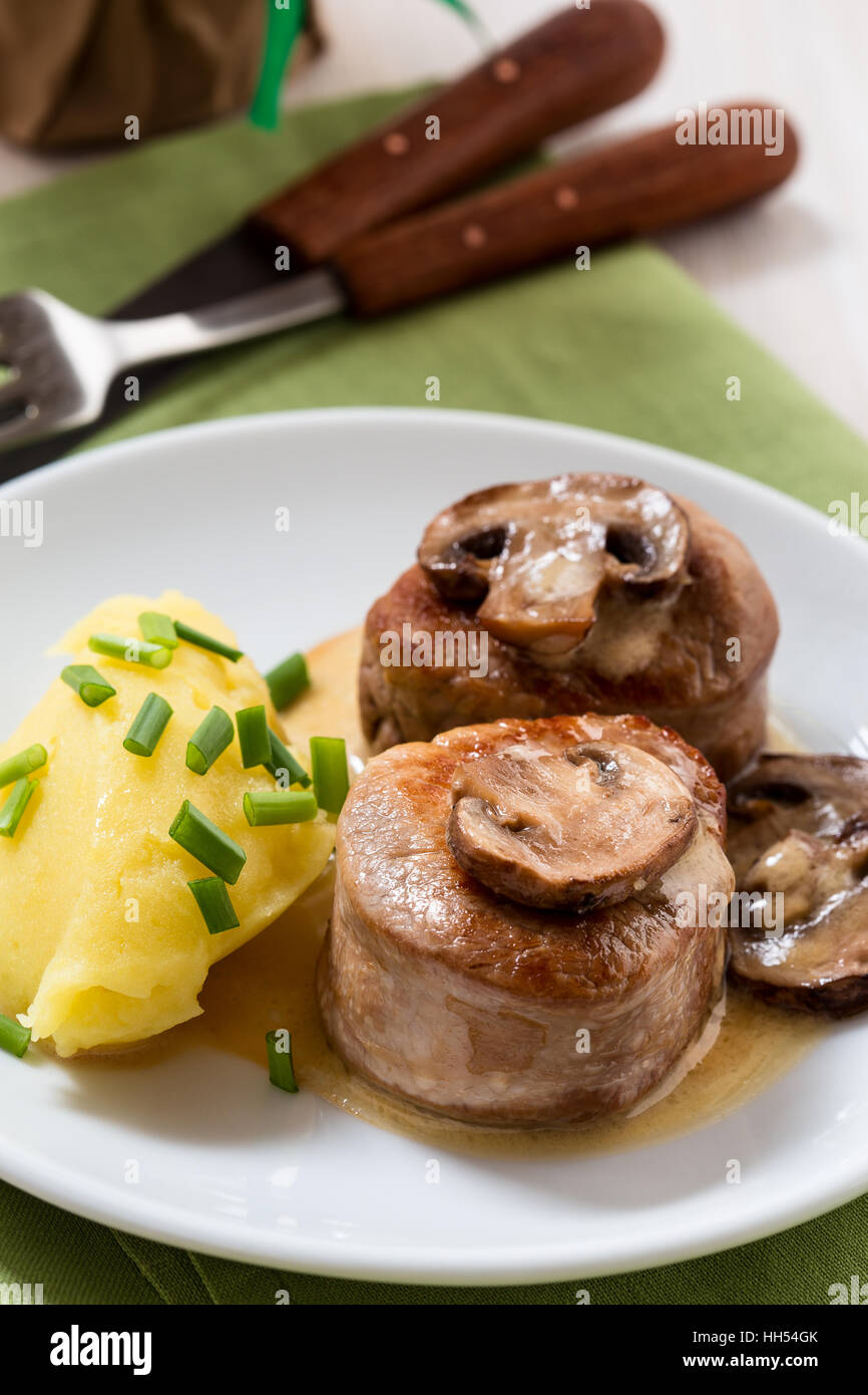 Homemade pork loin fillet with mashed potatoes and mushroom sauce on