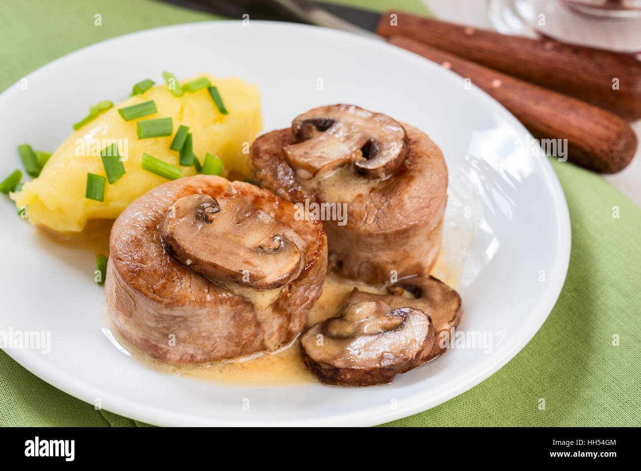 Homemade pork loin fillet with mashed potatoes and mushroom sauce on