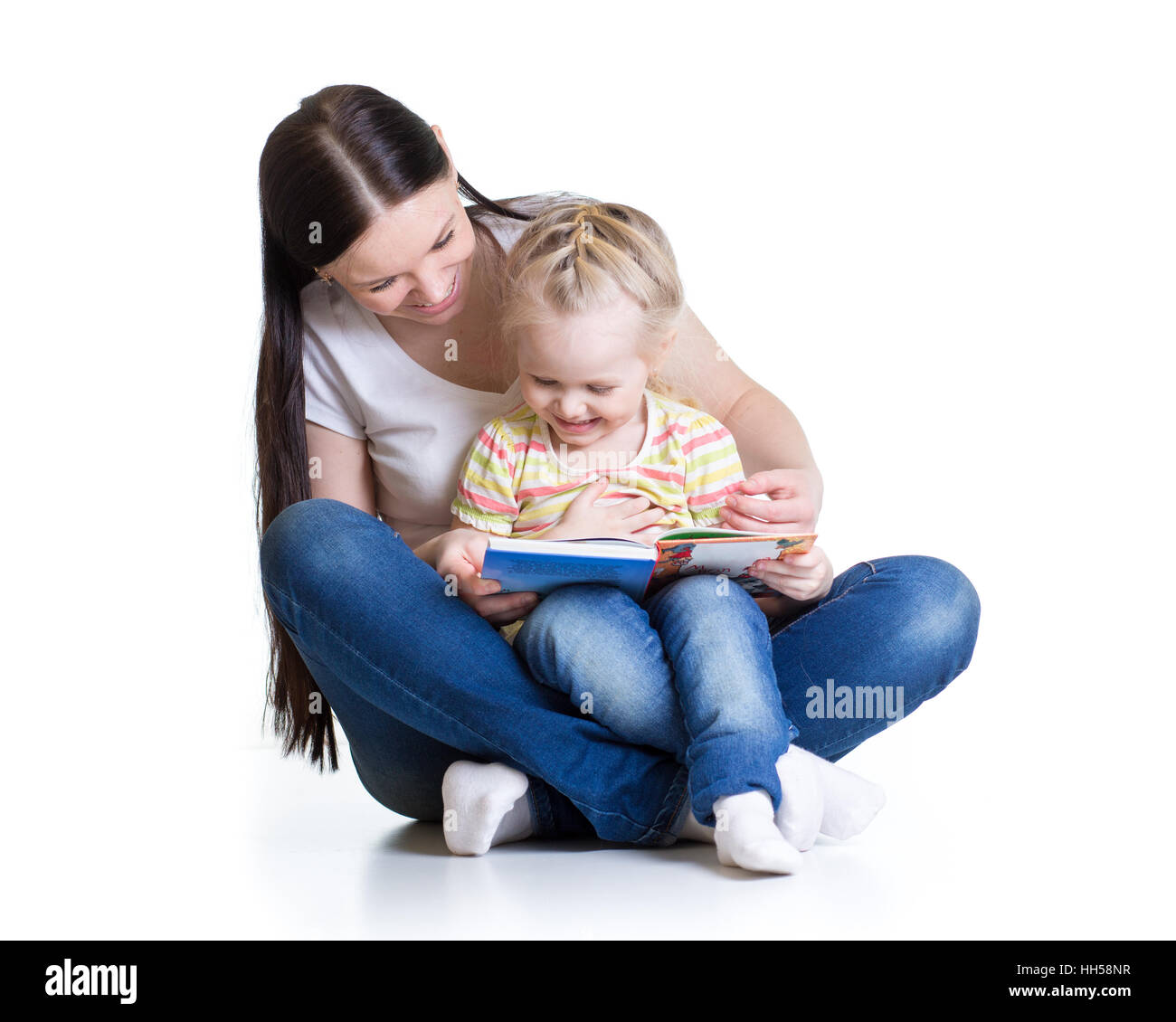 happy mother reads a book to baby girl isolated Stock Photo