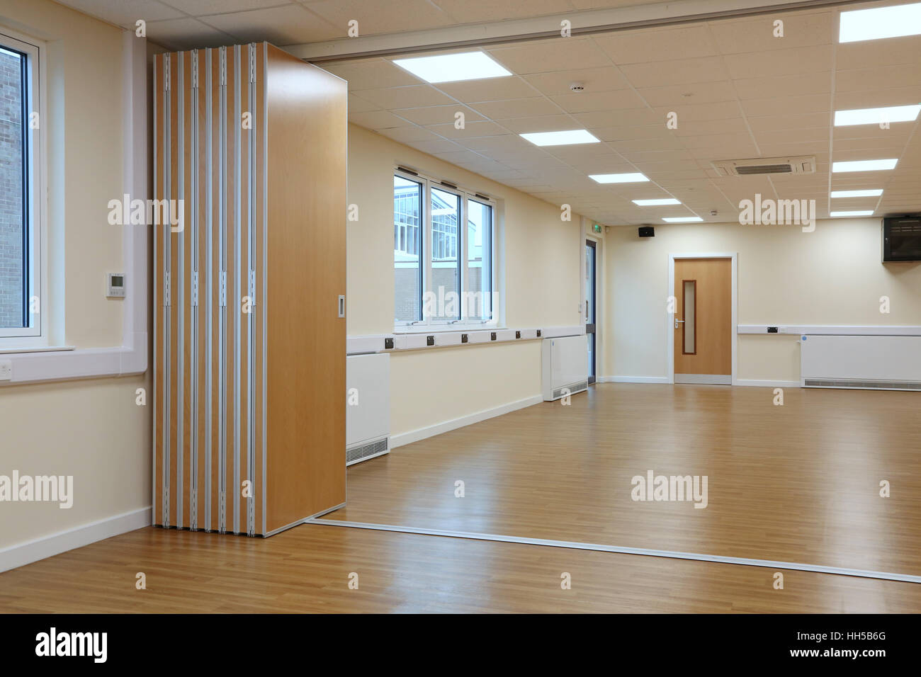 a folding,sliding acoustic partition in use in a new school hall in Oxfordshire, UK Stock Photo