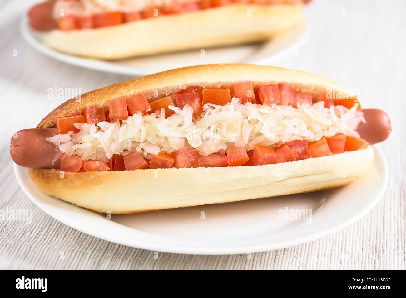 Chilean Completo Clasico (classical) or Aleman (German) traditional hot dog sandwiches tomato and sauerkraut Stock Photo