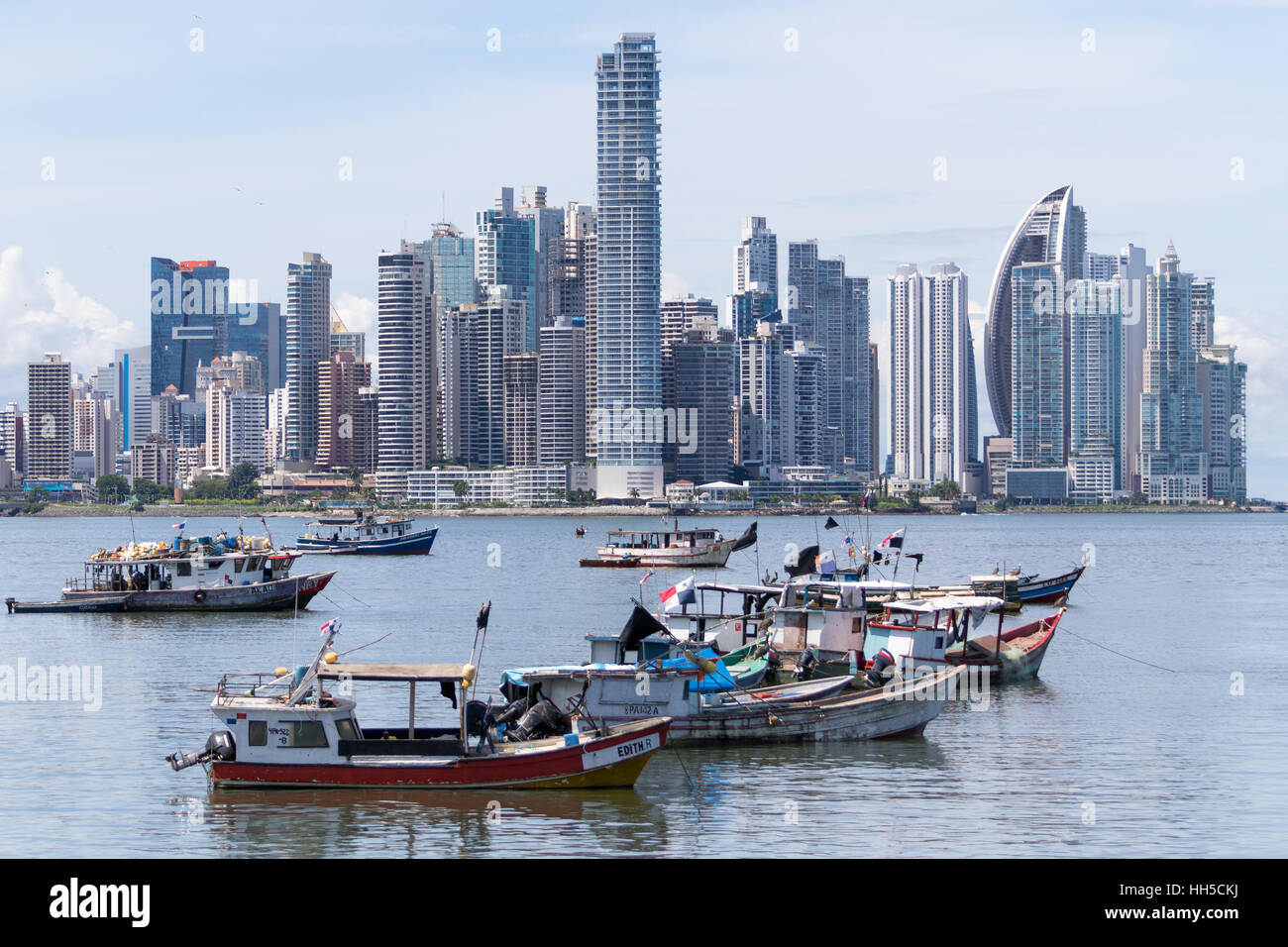 June 15, 2016 Panama City, Panama: small fishing boats floating on the water with the modern downtown high-rises buildings Stock Photo