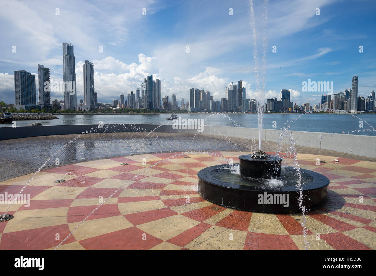 June 15, 2016 Panama City, Panama:  water fountain in the scorching heat of the midday sun with high-rises Stock Photo