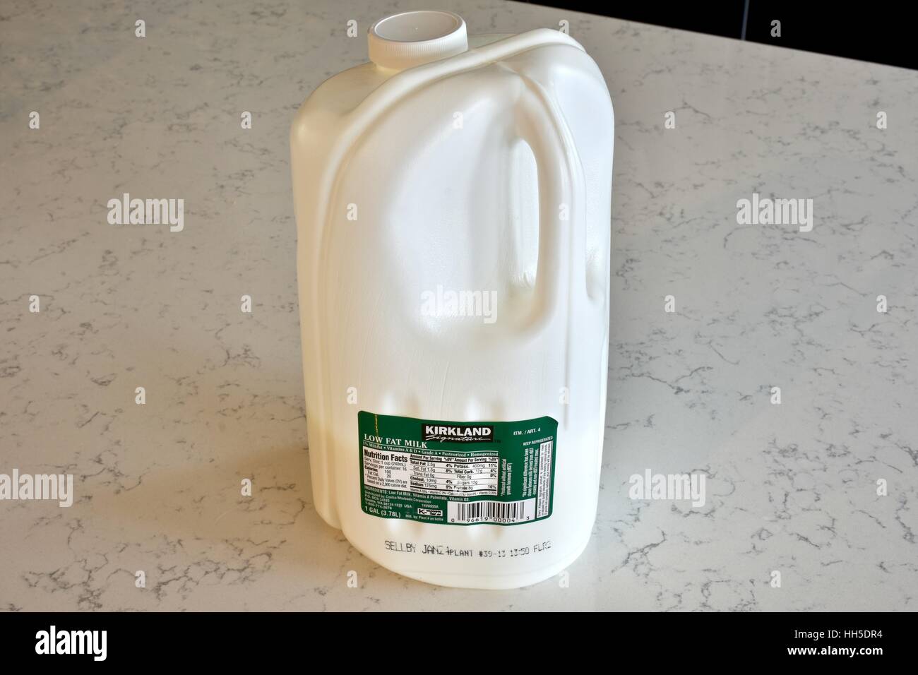 https://c8.alamy.com/comp/HH5DR4/a-kirkland-brand-gallon-of-milk-on-a-white-marble-surface-HH5DR4.jpg
