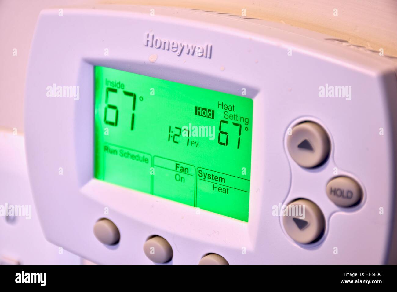 An electronic thermostat on the wall of a residential home Stock Photo