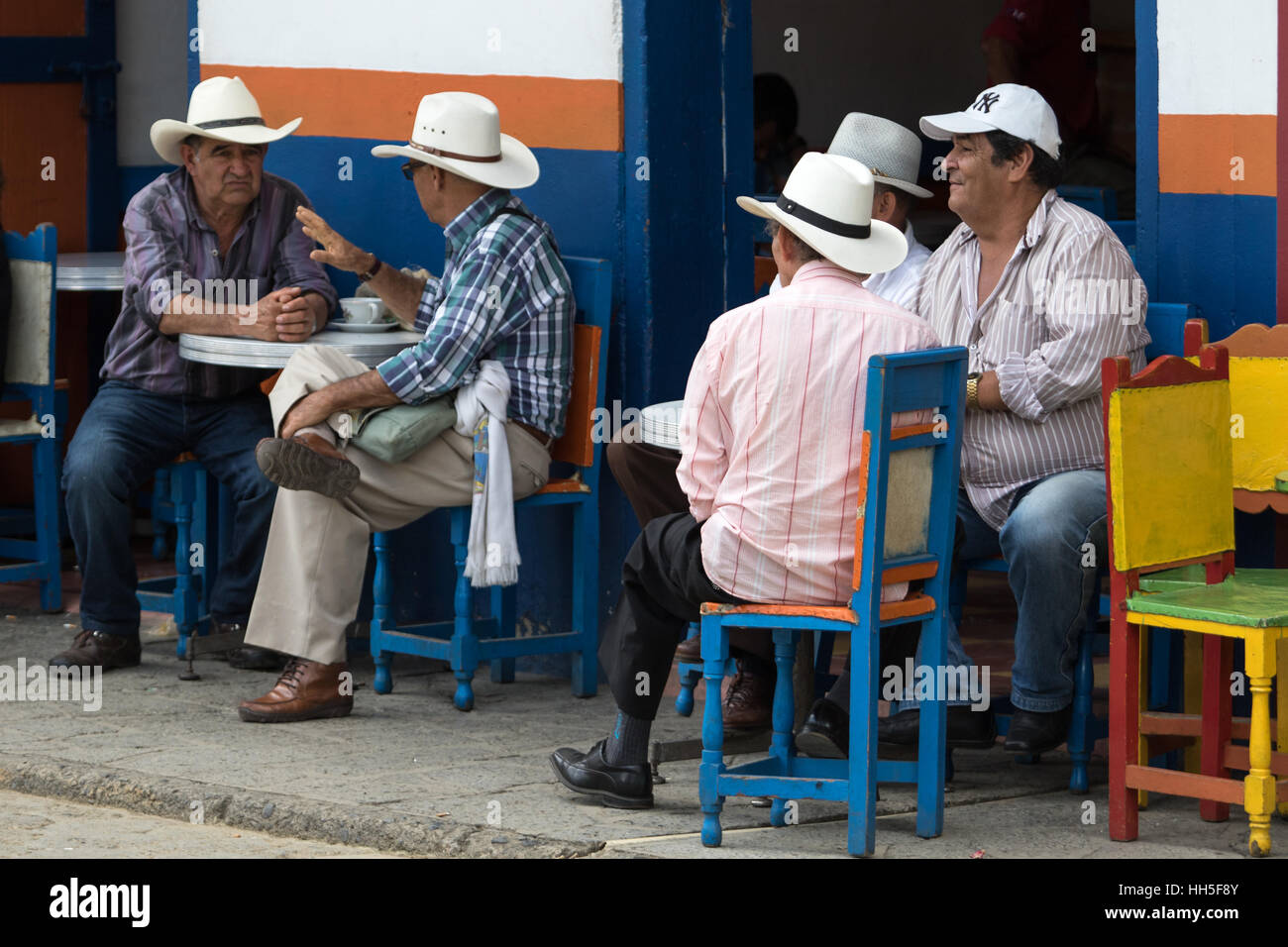 Antioquia, Colombia, El Jardin, South America, Colombian men table  having conversations outdoors on the patio of a café Stock Photo
