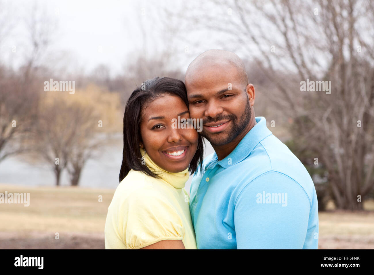 Loving happy African American couple hugging and smiling Stock Photo ...
