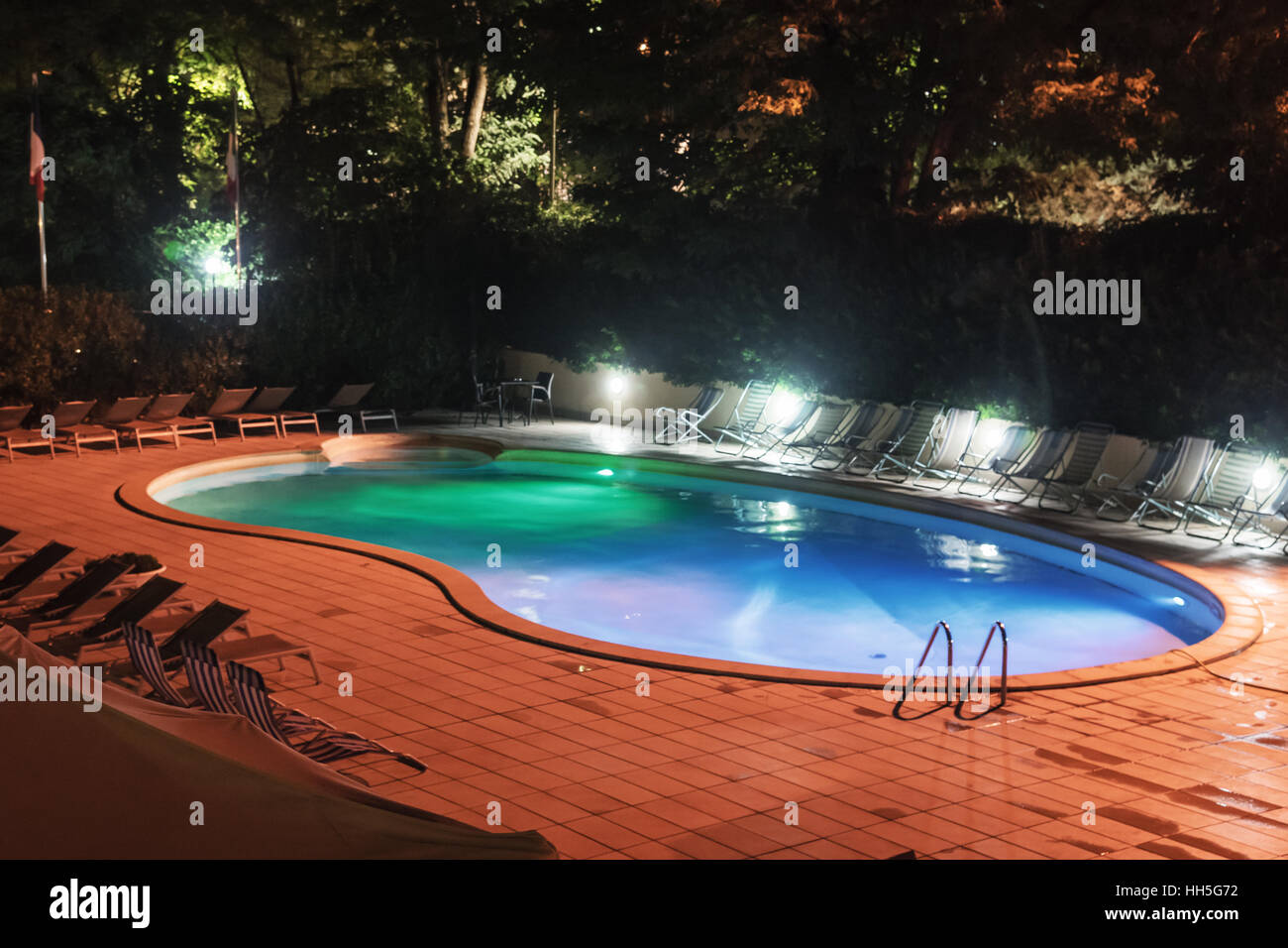 Colorful hotel  swimming pool at night, Rome, Italy, Europe Stock Photo