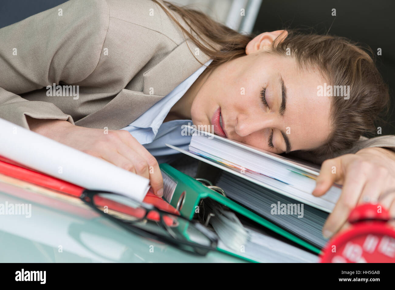tired businesswoman sleeping on the desk Stock Photo - Alamy