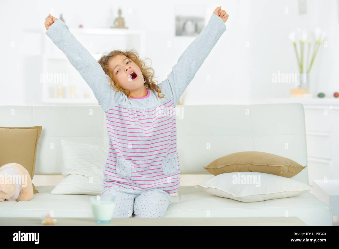 Little girl yawning Stock Photo - Alamy