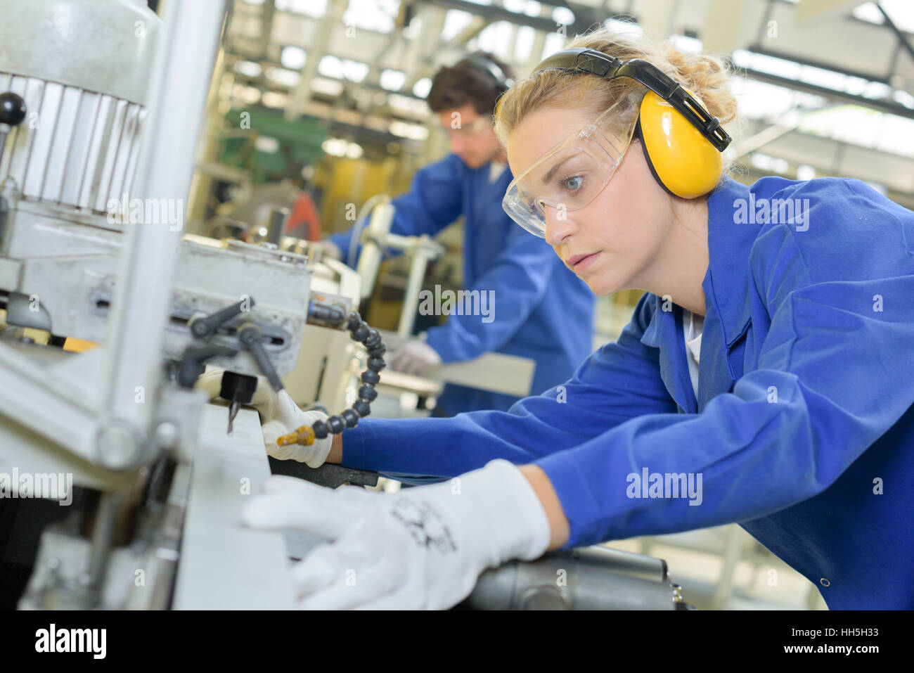 Woman using industrial machine Stock Photo Alamy