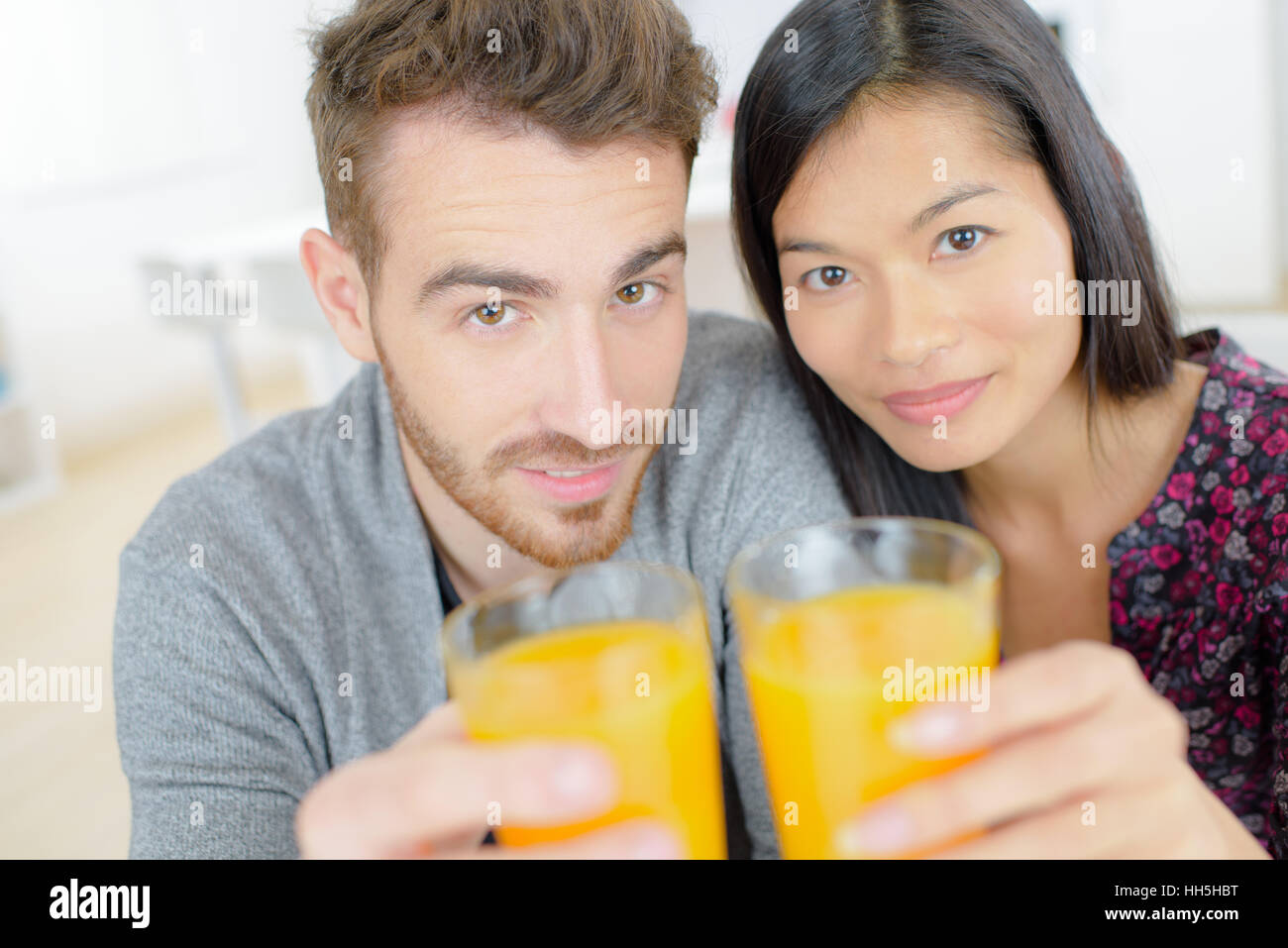 Couple drinking orange juice Stock Photo Alamy