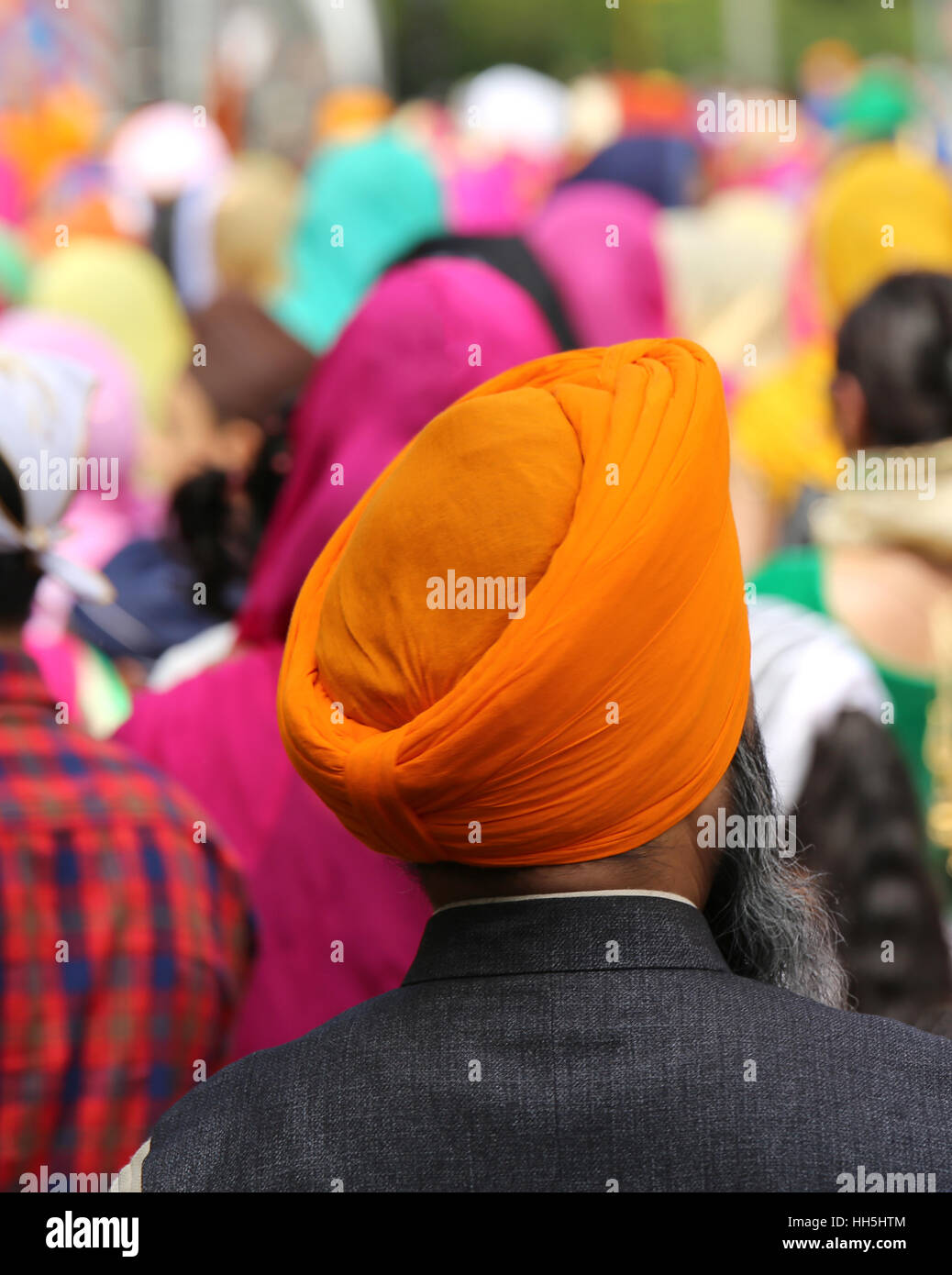 man with orange turban and thick beard during the religious event Stock Photo