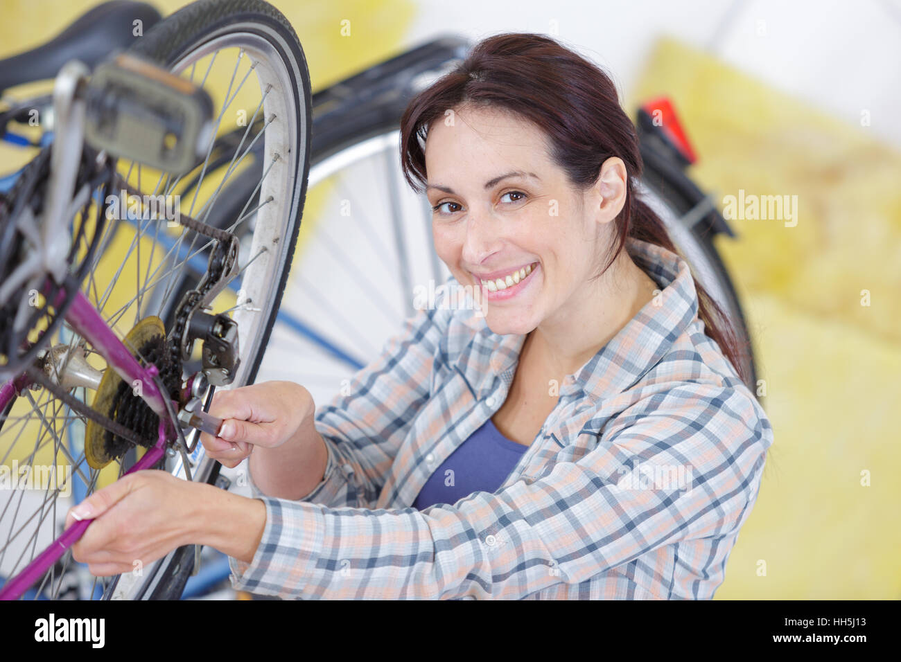 female mechanic in installing or repairing a bicycle wheel