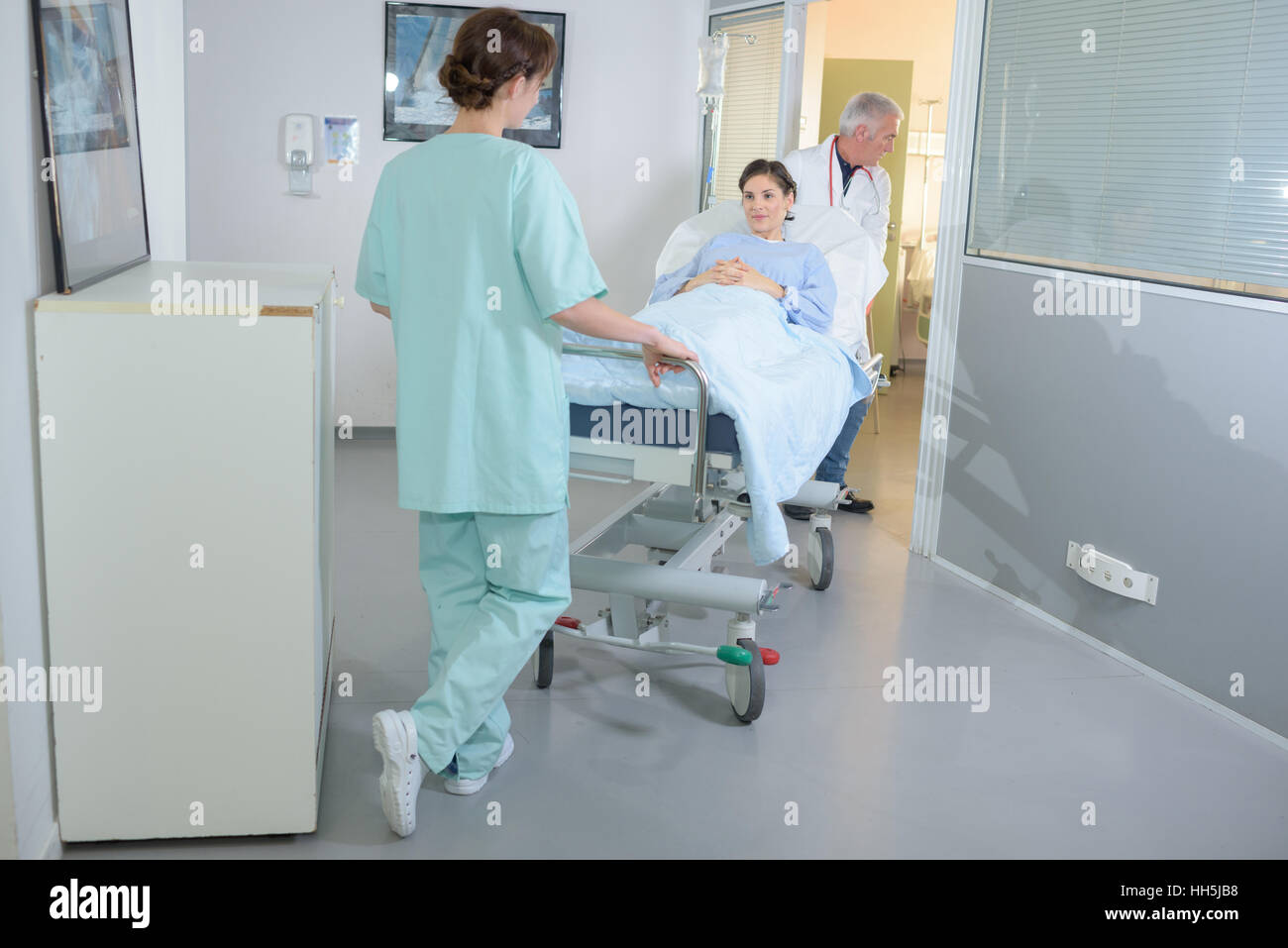 Patient being wheeled on hospital stretcher Stock Photo