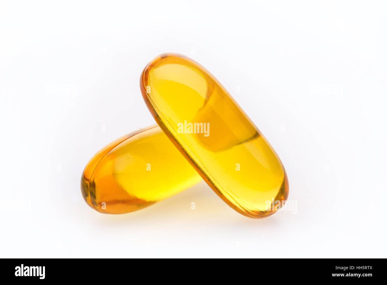 Cod Liver Oil capsules against a white background Stock Photo