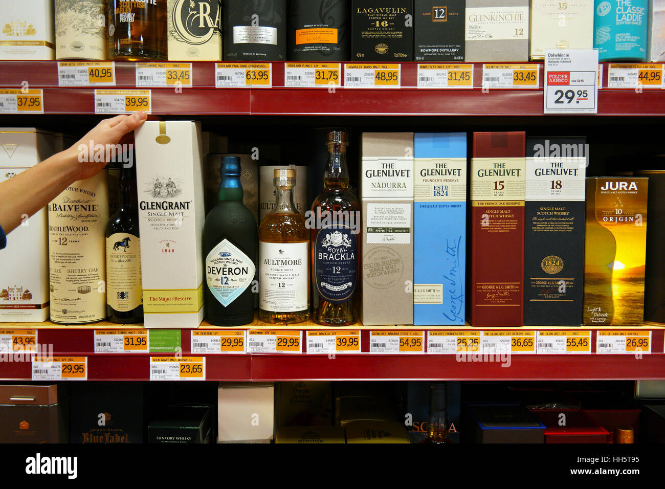 Boxes with bottles of whisky at a shop Stock Photo