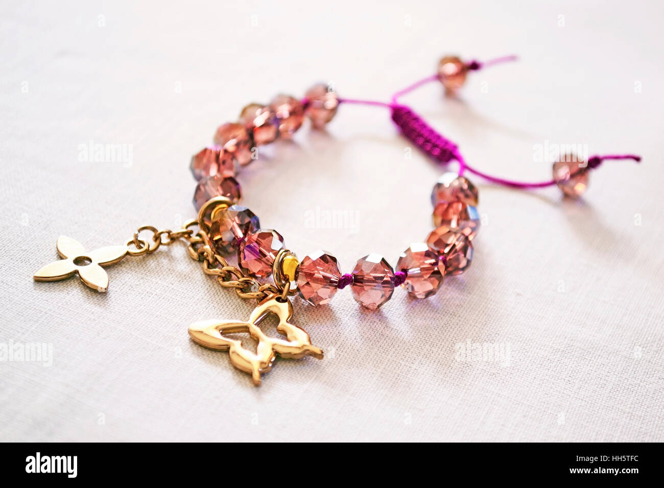 A gold charm bracelet with numerous gold charms Stock Photo - Alamy