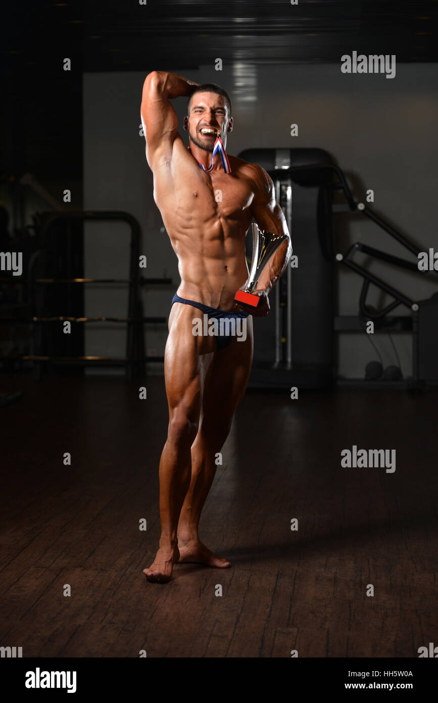 Bodybuilder Competitor Showing His Winning Medal - Male Fitness ...