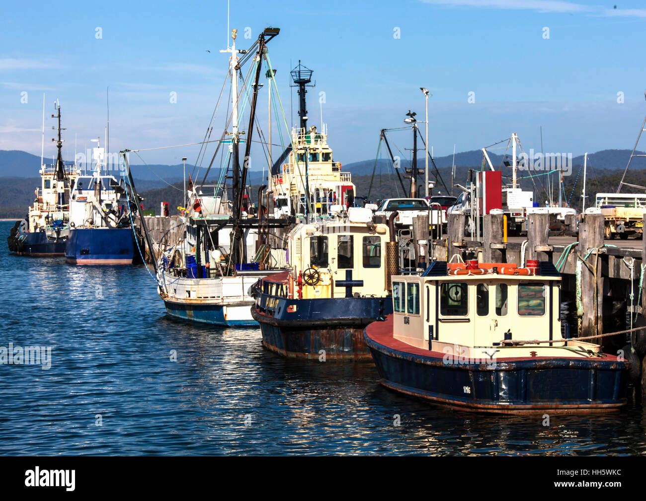 Fishing boats moored after off-loading their catch at Eden wharf Stock Photo