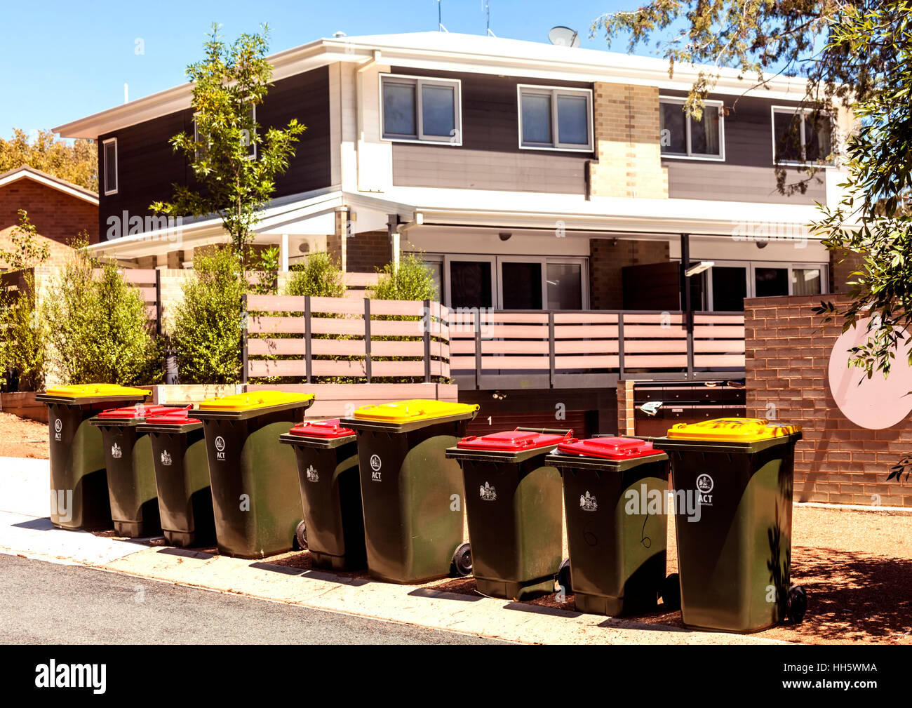 Waste bins lined up outside housing complex in Canberra Stock Photo Alamy