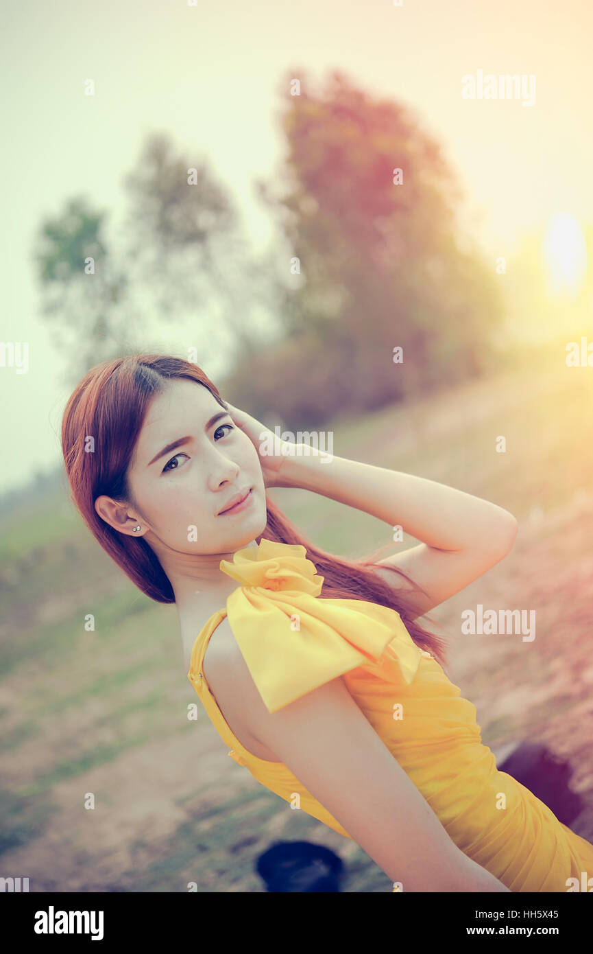 Portrait of Asia Beautiful woman in yellow dress on nature Stock Photo ...