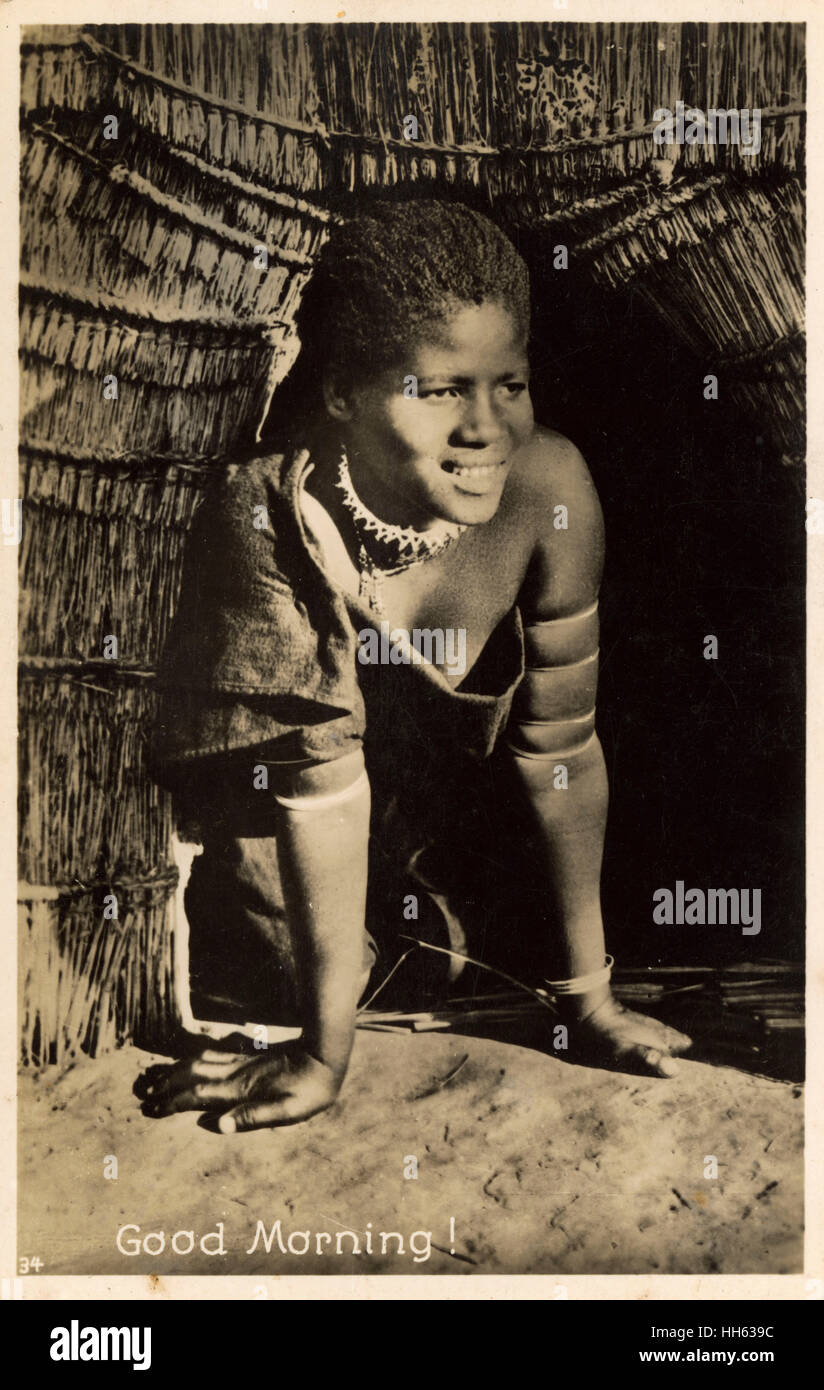 Young Zulu child, South Africa - Coming out of hut - morning Stock Photo