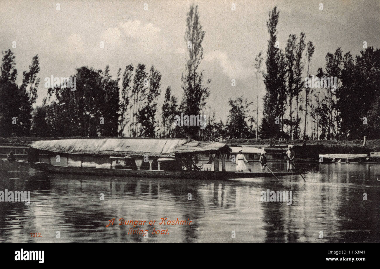 Houseboat (Dungar) on a river, Kashmir, India Stock Photo