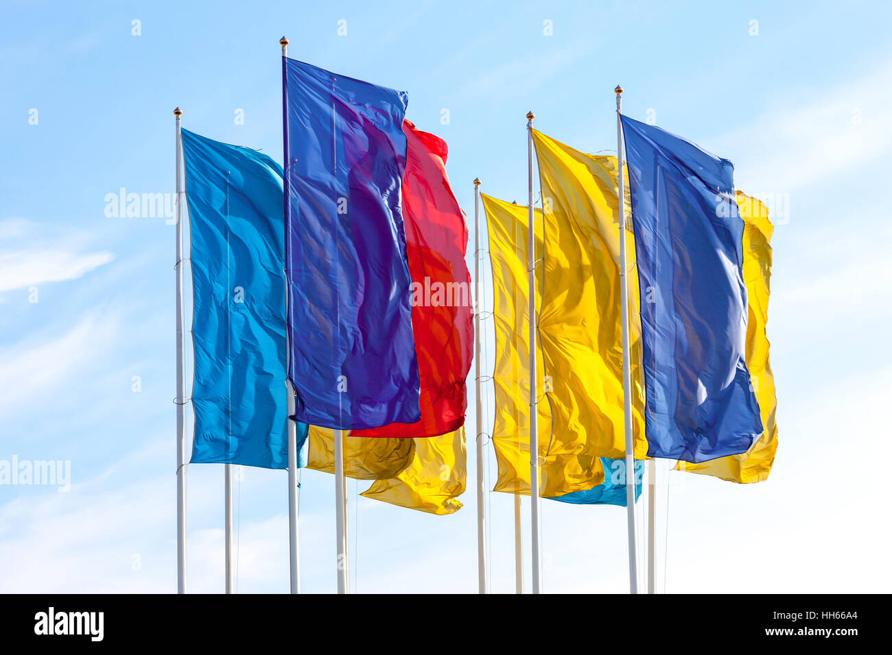 Colorful flags waving on blue sky background Stock Photo - Alamy
