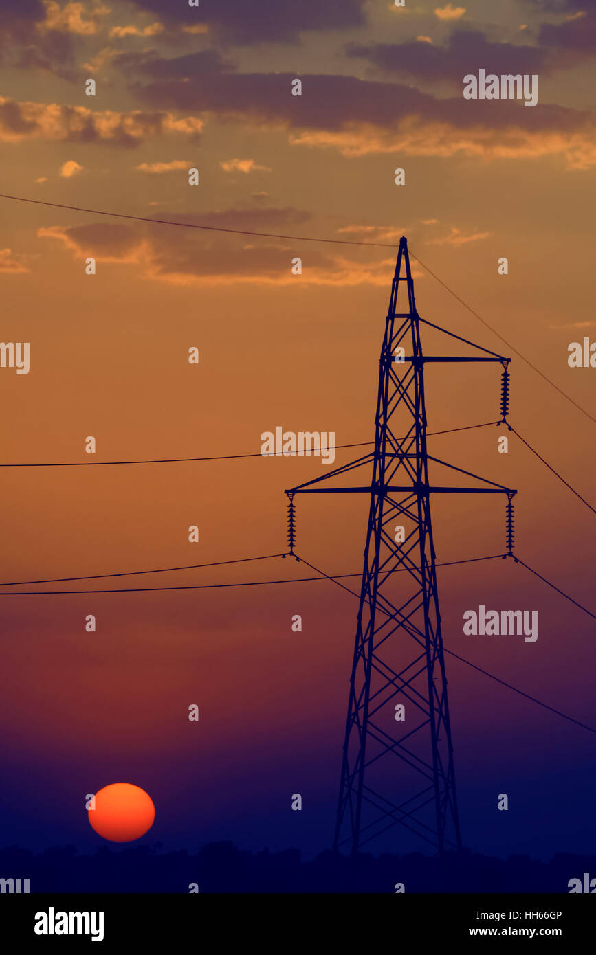 Electricity pylon at sunset in India, Rajasthan province. Stock Photo
