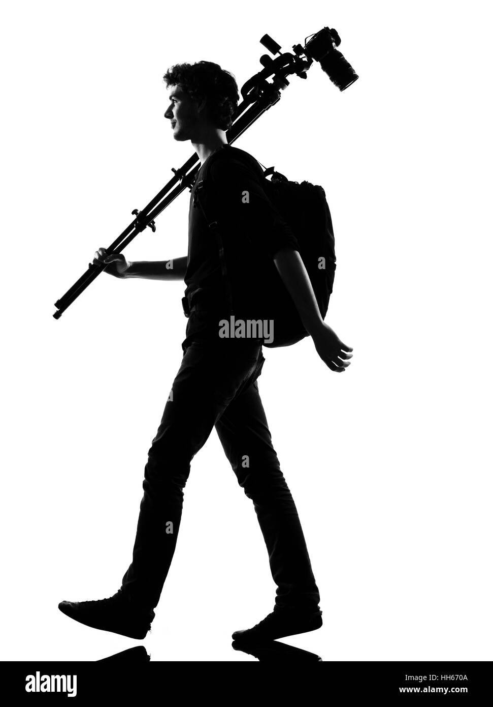 young man photographer silhouette in studio isolated on white ...