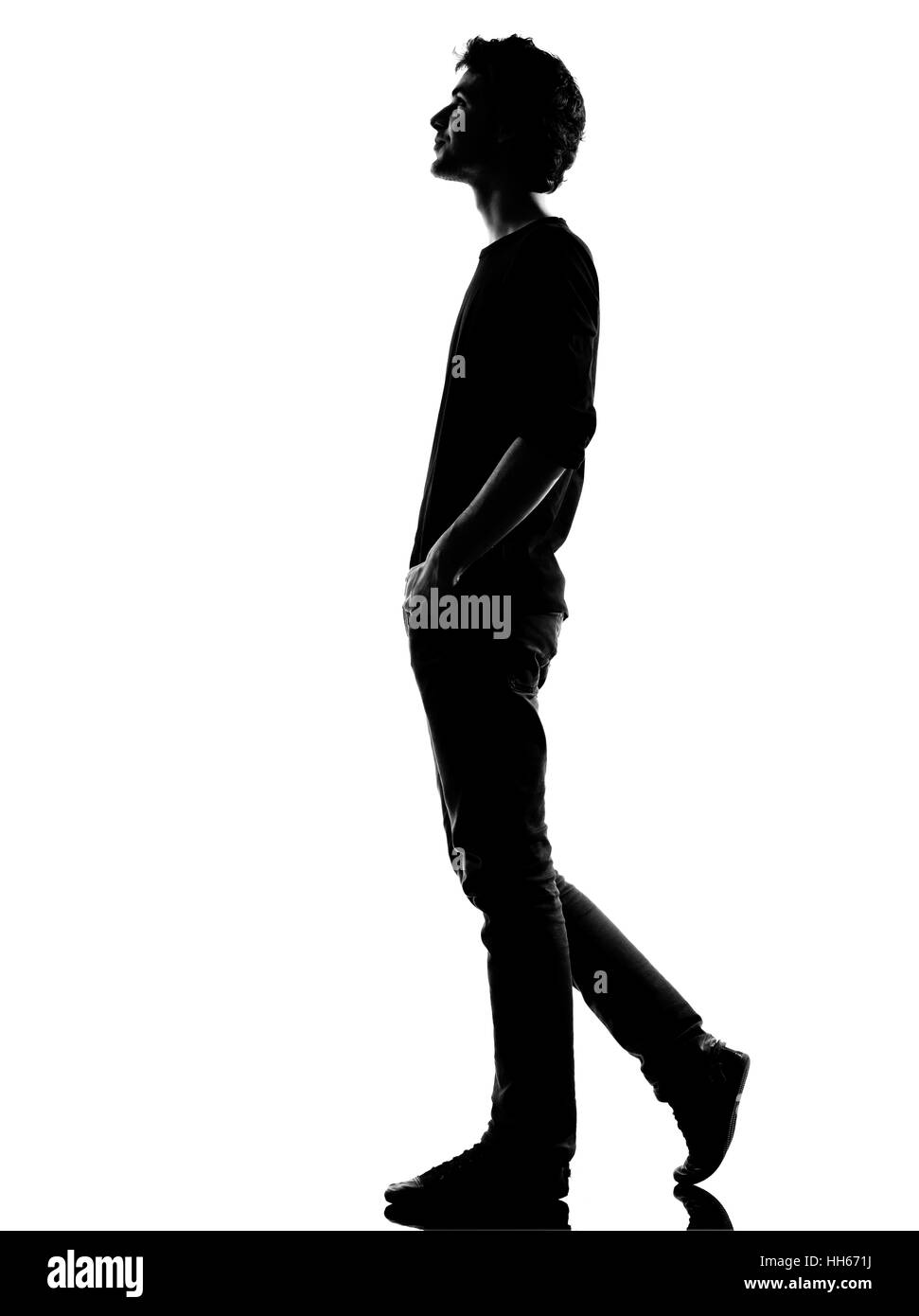 young man walking happy smiling silhouette in studio isolated on white ...
