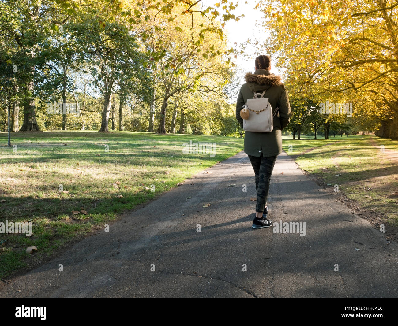 Young woman walking in the park at morning Stock Photo - Alamy