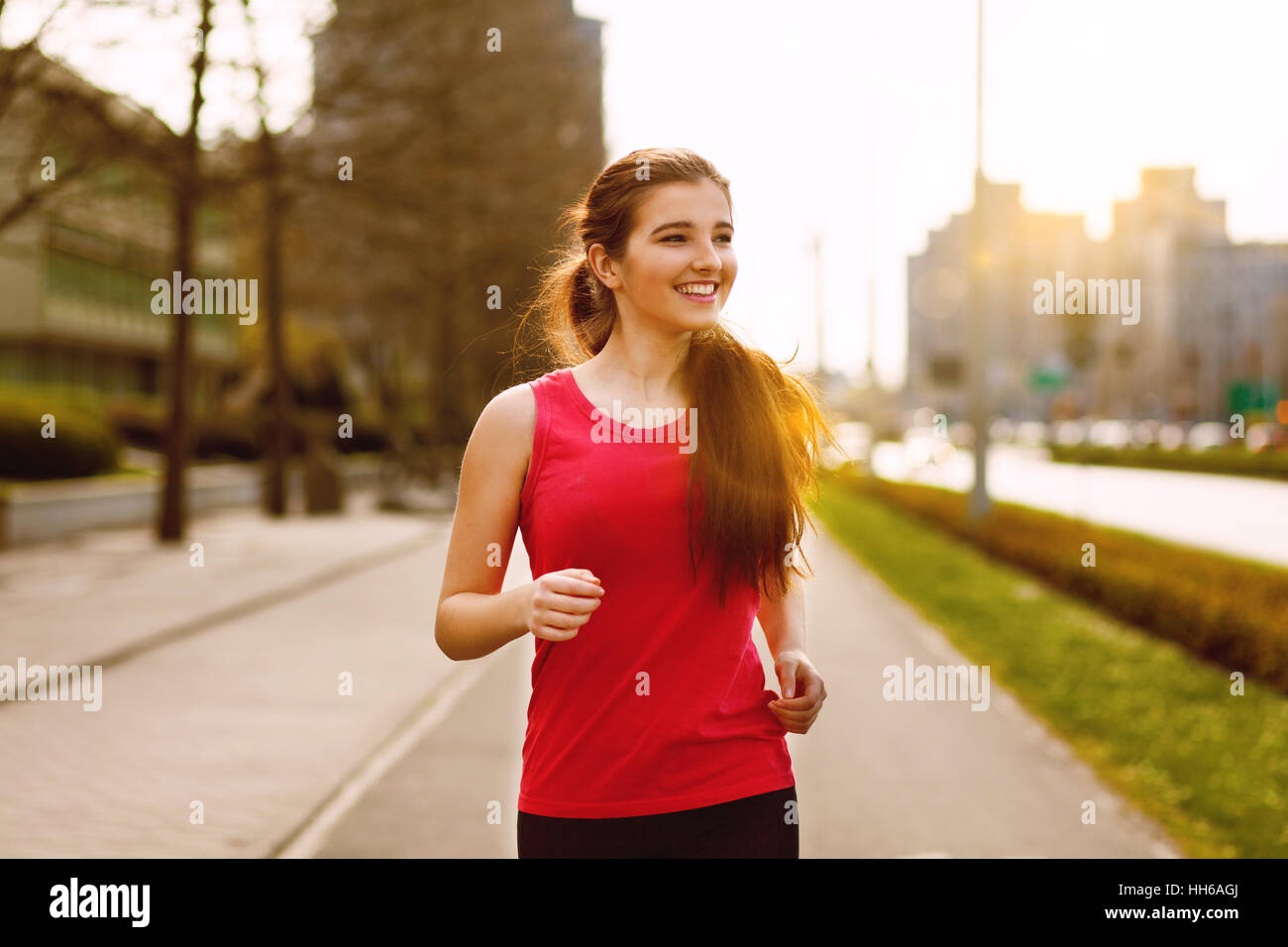 Young beautiful woman running in the city Stock Photo