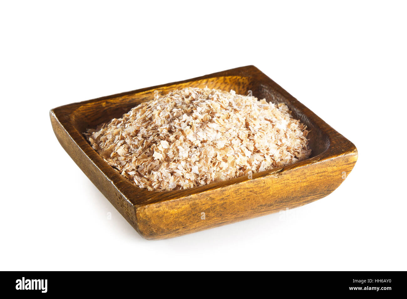 Wheat bran in wooden bowl isolated on white background Stock Photo