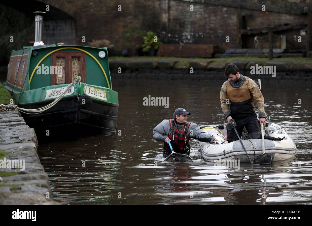 Fishery scientists (from left) Peter Dennis and Tom Brook use the electro-fishing method to collect fish from the Union Canal at Linlithgow before a three mile stretch is drained for maintenance checks. Stock Photo
