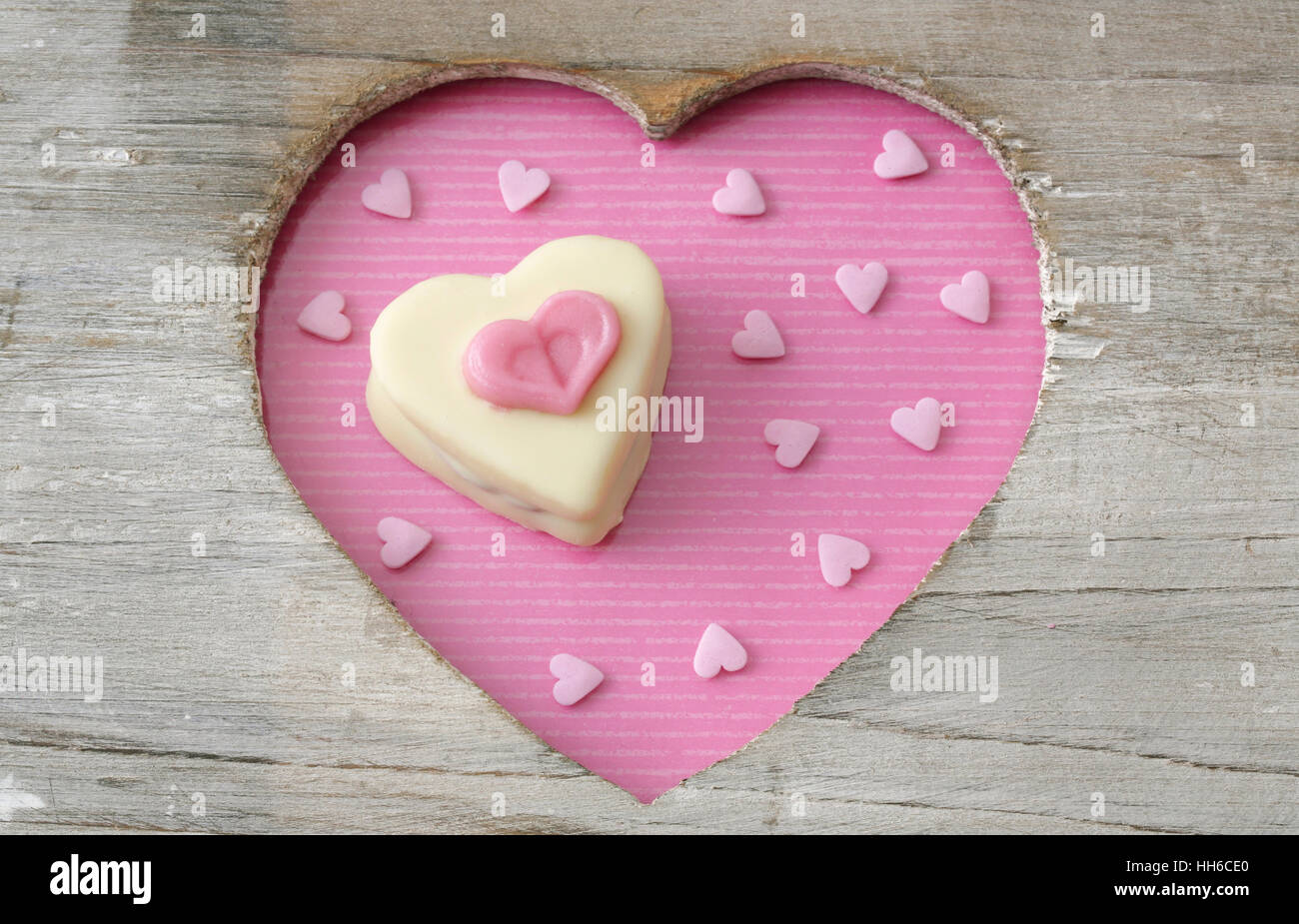 Heart shaped petit four for Valentines day in a wooden heart Stock Photo