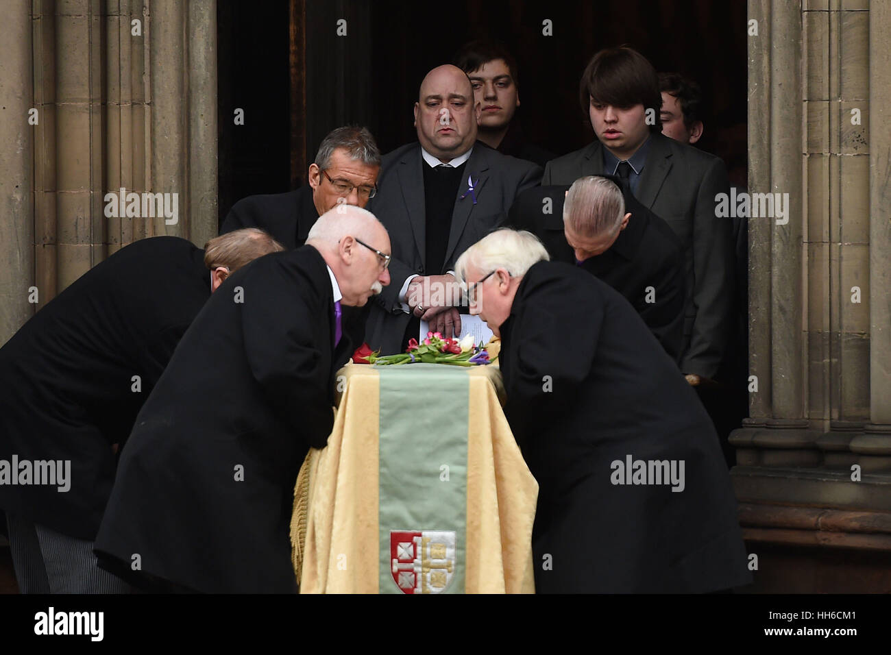 The coffin of victims' rights campaigner Jill Saward is carried out of Lichfield Cathedral in Staffordshire after her funeral as husband Gavin Drake and sons Fergus, Rory and Myles look on. Stock Photo