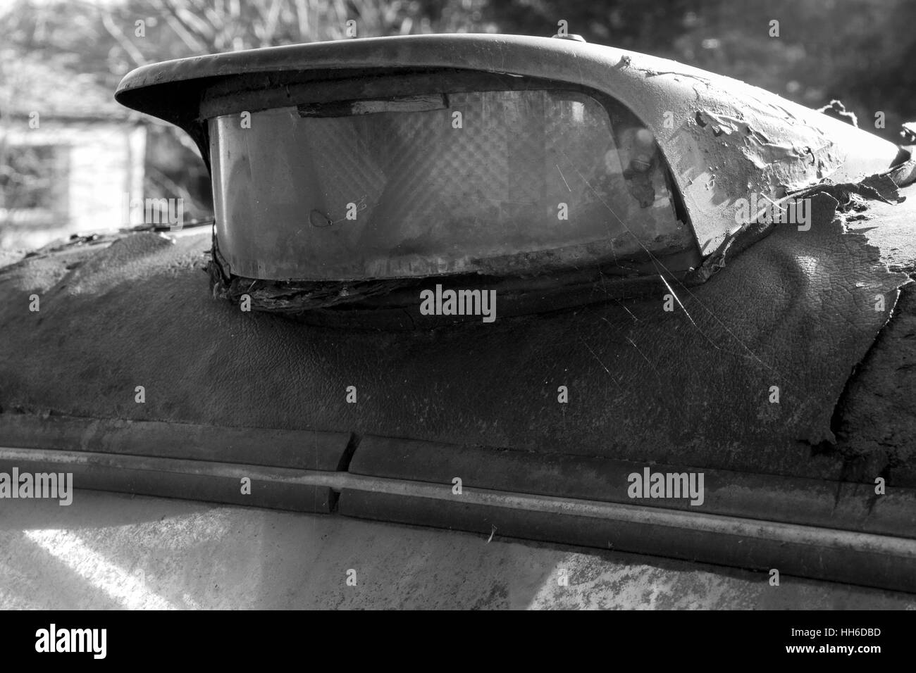 Black Cab to Nowhere: Monochrome Detail - Roof Light on an Abandoned Rusting and Dilapidated London Cab. Stock Photo