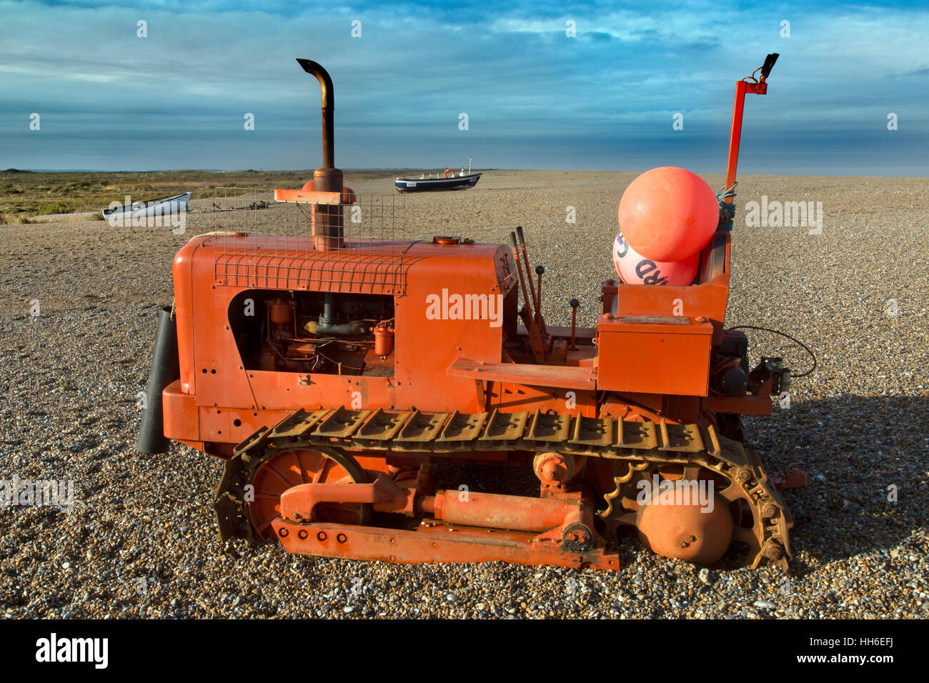 Marooned tractor and boat Cley beach Nature reserve Norfolk after a January tidal surge Stock Photo