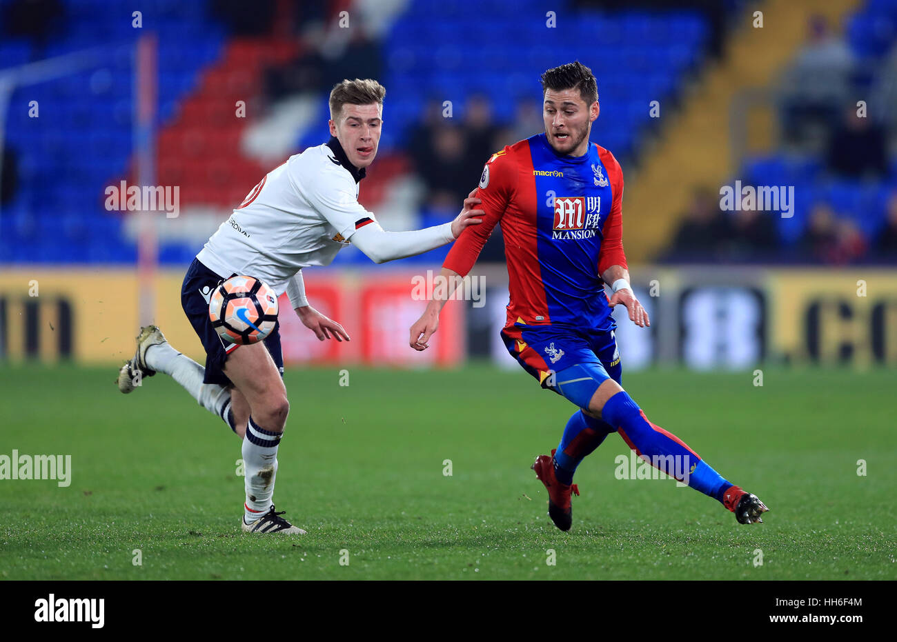 Crystal Palace's Joel Ward (right) and Bolton Wanderers' Josh Vela battle for the ball during the Emirates FA Cup, third round replay match at Selhurst Park, London. Stock Photo