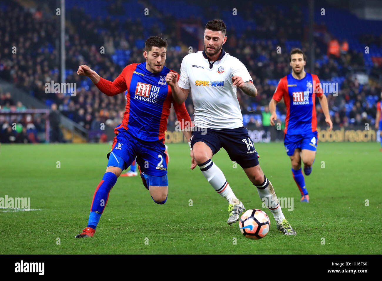 Crystal Palace's Joel Ward (left) and Bolton Wanderers' Gary Madine battle for the ball during the Emirates FA Cup, third round replay match at Selhurst Park, London. Stock Photo